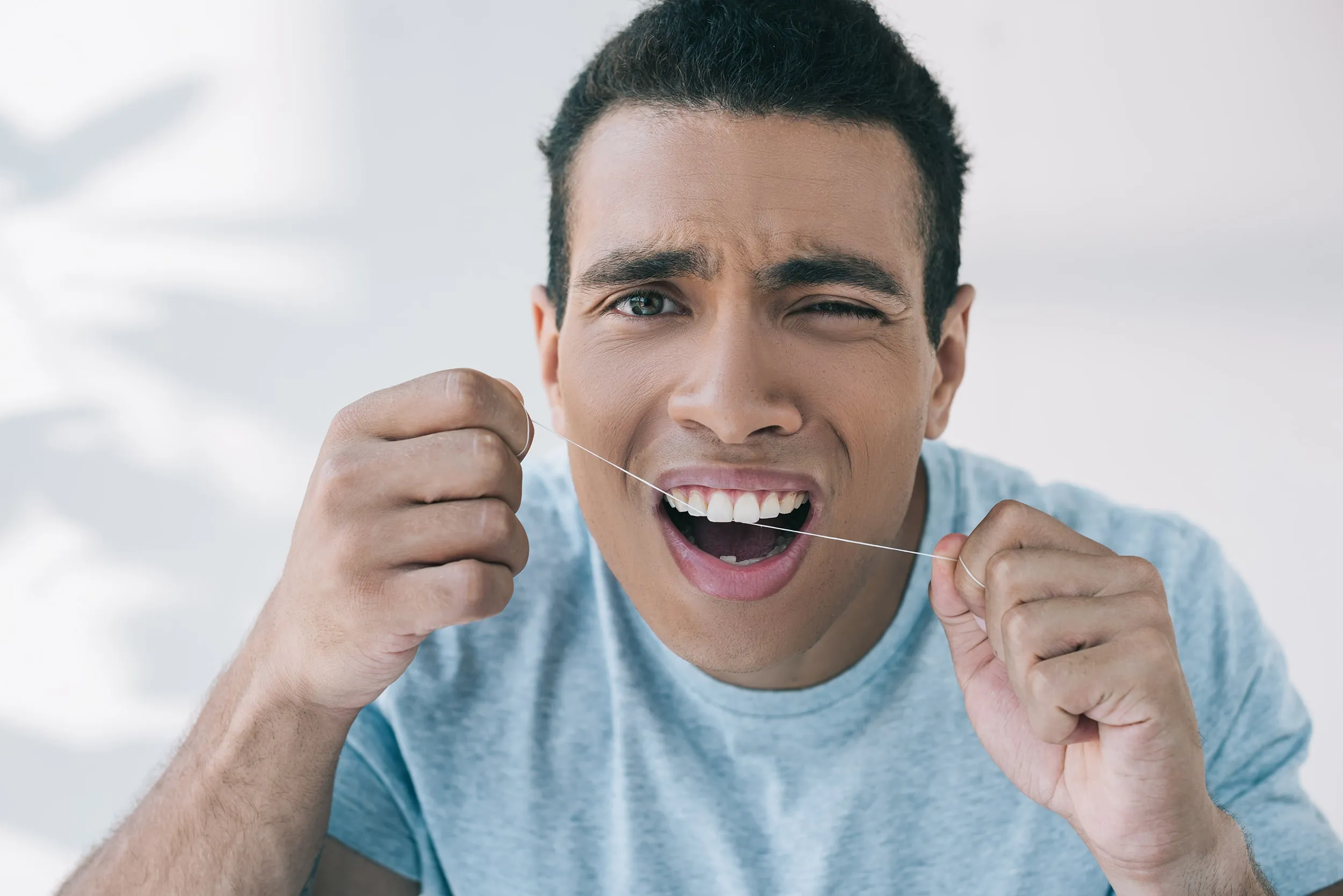 A man holding his jaw in pain