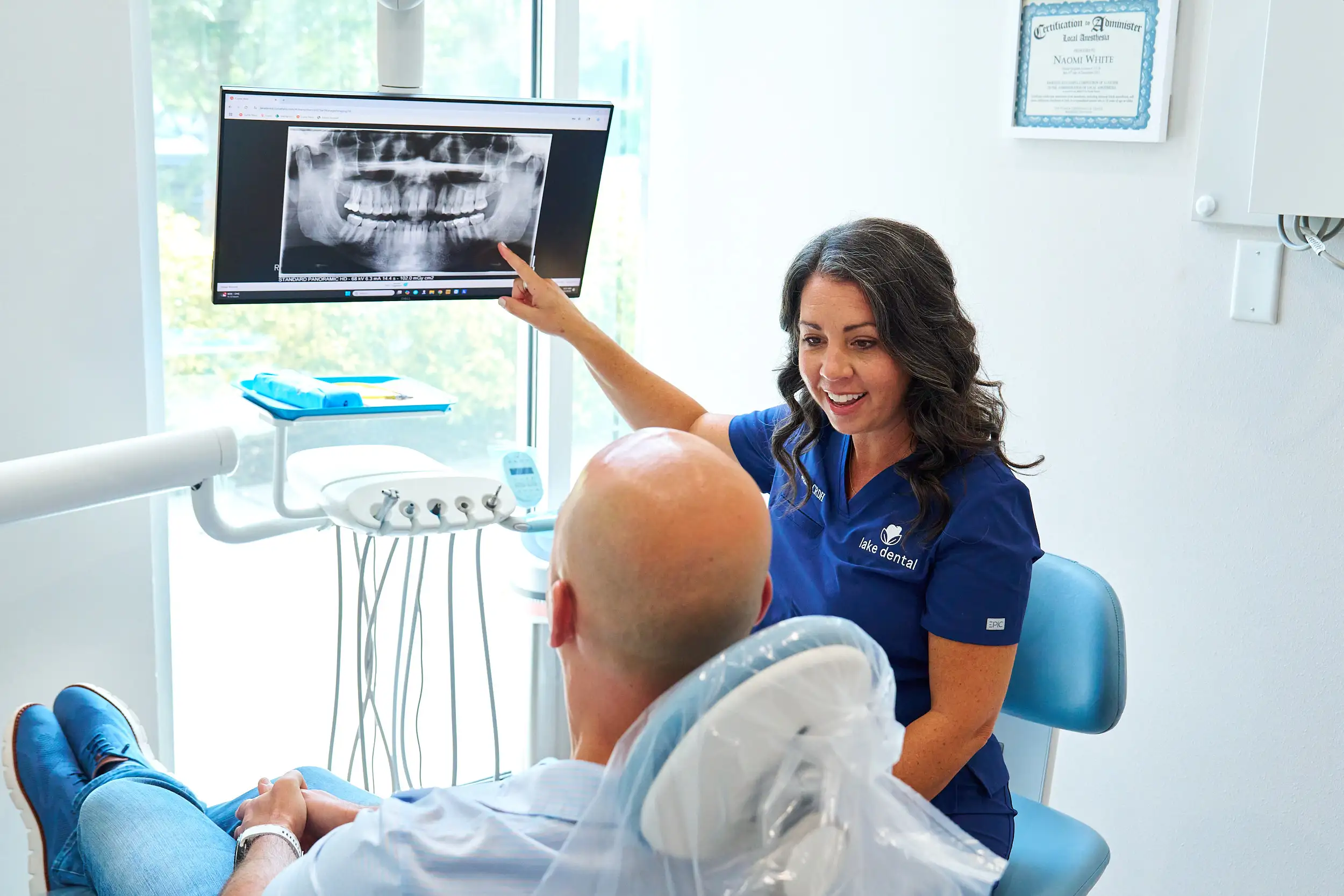 A Lake Dental dentist reviewing an x-ray with a patient